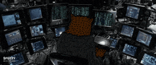 a cartoon of a cat sitting in front of a bunch of computer monitors with the words fuzzy on the bottom right