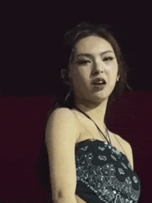 a woman in a black dress is making a funny face with her mouth wide open .
