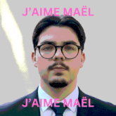 a man wearing glasses and a suit has the words j'aime mael above him