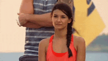 a man and a woman are standing next to each other on a beach .