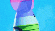 a rainbow colored rabbit is standing in a field of tents .