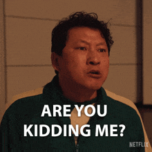 a man says " are you kidding me " while wearing a green jacket