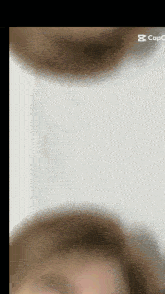 a blurred image of a person 's face with the letter s on the bottom right