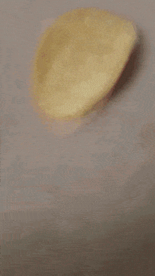a blurred image of a person 's face with a gray background .