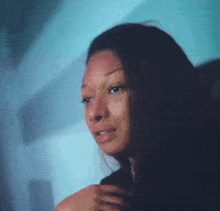 a close up of a woman 's face with a tear running down her face .