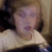 a blurry picture of a child playing a video game on a computer .