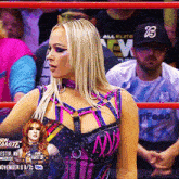 a woman in a wrestling ring is wearing a black hat with the number 13 on it