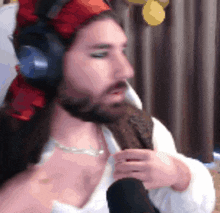 a man with a beard wearing headphones and a bandana on his head