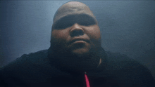 a close up of a man 's face in the dark
