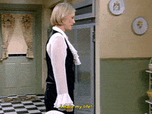 a woman is standing in front of a refrigerator and saying i hate my life