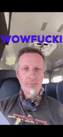 a man sitting in a bus with the words wowfuck written above him