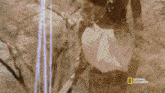 a national geographic advertisement with a man in a white cloth