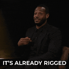 a man in a suit says it 's already rigged with his hands