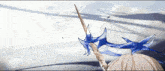 a drawing of a sword with a blue ribbon on it