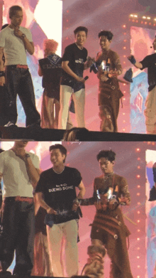 a man wearing a black t-shirt with the word duong on it stands on stage