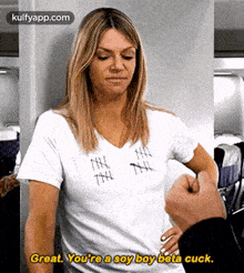 a woman wearing a white t-shirt that says ' great you 're a soy boy beta cuck '