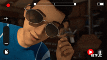 a man wearing sunglasses and a blue shirt is being recorded on a netflix video