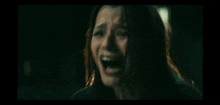 a close up of a woman screaming with her mouth open