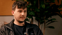 a man wearing a patagonia jacket and a shirt with the word min on it