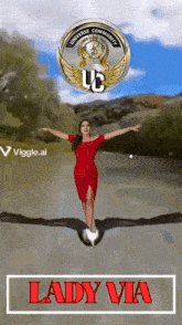 a lady in a red dress is standing on an eagle 's back with a uc logo behind her