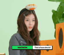 a woman wearing a headband with an egg on it and the name haewon at the bottom