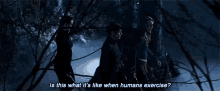 a group of people are walking through a dark forest and a man is asking is this what it 's like when humans exercise