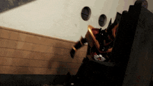a person in a robot costume is standing in front of a wall with holes in it