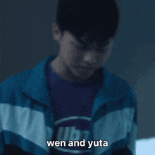 a man in a blue and white jacket is standing under a bridge with the words wen and yuta below him