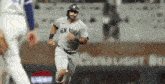 a new york yankees baseball player is running on the field during a baseball game .