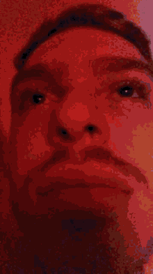a close up of a man 's face with a very blurry background