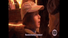 a young boy wearing a baseball cap is talking to someone and says " rendierhoedje hebben "