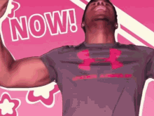 a man in an under armour shirt is flexing his arm