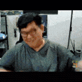 a man wearing glasses is sitting in front of a computer