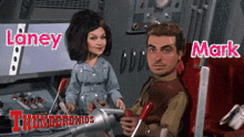 a man and a woman are sitting next to each other and they are from the thunderbirds
