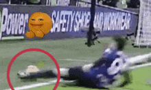 a soccer goalie is diving to catch a ball in front of a power safety shoe and workwear sign