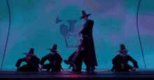 a man in a hat stands in front of a group of men