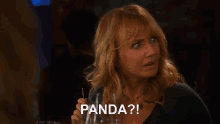 a woman is holding a glass with a straw and says panda