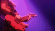 a person is playing a red guitar in front of a purple light