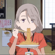 a girl is eating noodles with chopsticks and a name tag