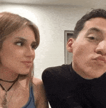 a man and a woman are looking at each other while making funny faces .