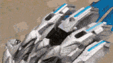 a close up of a robot with a blue stripe on the bottom