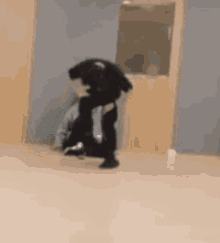 a blurry picture of a man carrying another man in a room .