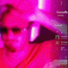 a man wearing sunglasses and headphones is standing in front of pink balloons