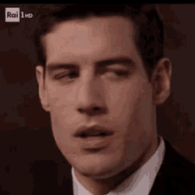 a close up of a man 's face with rai 1 hd on the bottom right