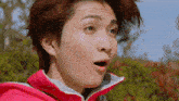 a close up of a man 's face with a surprised look on his face