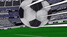 a soccer ball is flying through the air in front of a stadium that says cote d ' or