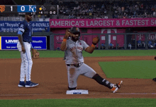 a baseball game is being played in front of a banner that says america 's largest and fastest