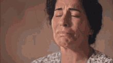 a close up of a woman 's face with her eyes closed .