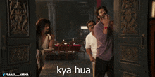 three men are standing in front of a door with the word kya hua written on it