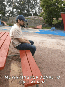 a man sits on a red bench waiting for someone to call at 6 pm